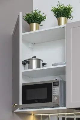 a microwave oven in a kitchen with potted plants at Kazimierz Studio with Jacuzzi by Renters Prestige in Kraków