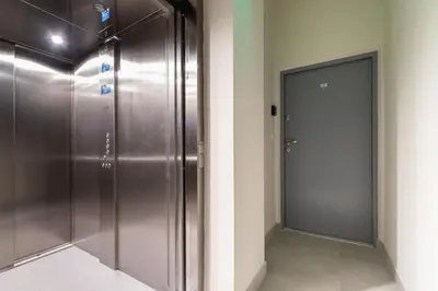 a hallway with a metal elevator and a door at Kazimierz Studio with Jacuzzi by Renters Prestige in Kraków