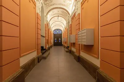 a hallway in a building with orange walls and a ceiling at Kazimierz Studio with Jacuzzi by Renters Prestige in Kraków