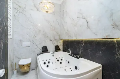 a bathroom with a white tub and a sink at Kazimierz Studio with Jacuzzi by Renters Prestige in Kraków