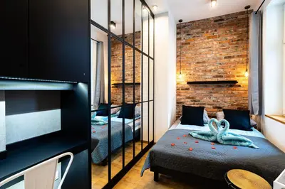 a bedroom with a bed and a brick wall at Large 75 m2 Apartment for 6 guests next to Wawel Castle in Kraków