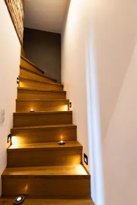 a stairway with led lights on the stairs at Large 75 m2 Apartment for 6 guests next to Wawel Castle in Kraków