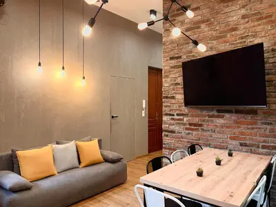 a living room with a couch and a table at Large 75 m2 Apartment for 6 guests next to Wawel Castle in Kraków