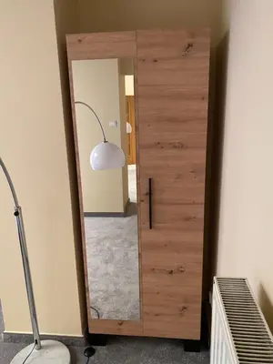 a bedroom with a large bed and a table at City Apartment Getta in Kraków