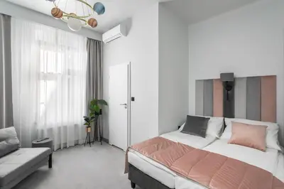 a bedroom with a large bed and a couch at Old Town Residence - Premium Aparthotel in Kraków