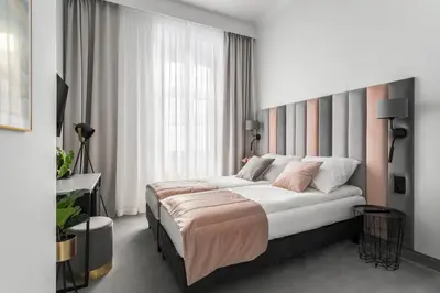 a bedroom with a bed and a large window at Old Town Residence - Premium Aparthotel in Kraków