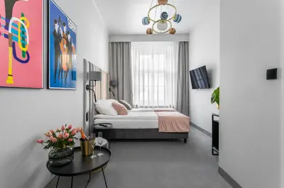 a bedroom with a bed and a table in a room at Old Town Residence - Premium Aparthotel in Kraków