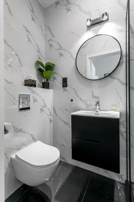 a bathroom with a white toilet and a mirror at Old Town Residence - Premium Aparthotel in Kraków