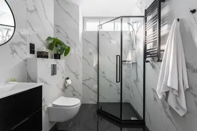 a bathroom with a toilet and a glass shower at Old Town Residence - Premium Aparthotel in Kraków