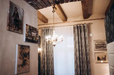 a room with a chandelier and pictures on the walls at Native Apartments Dunajewskiego 2 in Kraków