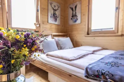 a bedroom with a bed with flowers in it at Domki pod Halą Krupową in Ohłypów