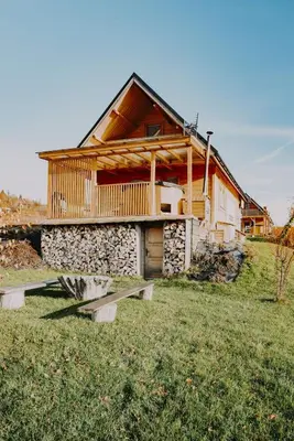 a log cabin with a bench in front of it at Domki pod Halą Krupową in Ohłypów