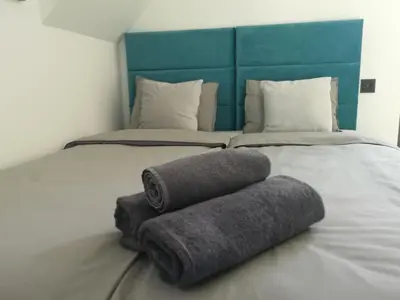 two towels on a bed in a room at Dream House 8 osób - cały dla Ciebie in Gdów