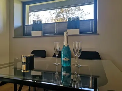 a bottle of wine and two wine glasses on a table at Dream House 8 osób - cały dla Ciebie in Gdów