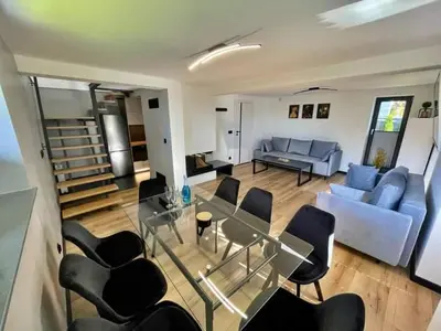 a living room with a couch and a table and chairs at Dream House 8 osób - cały dla Ciebie in Gdów