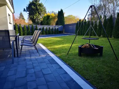 a chair and a swing in a yard at Dream House 8 osób - cały dla Ciebie in Gdów