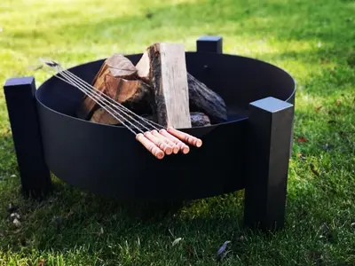 a fire pit with a log and a stick at Dream House 8 osób - cały dla Ciebie in Gdów