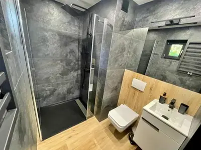 a bathroom with a shower and a toilet and a sink at Dream House 8 osób - cały dla Ciebie in Gdów