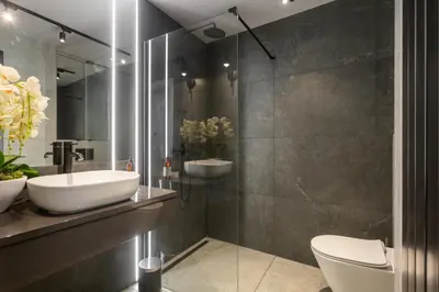 a bathroom with a sink and a toilet at Family Center Apartments in Kraków