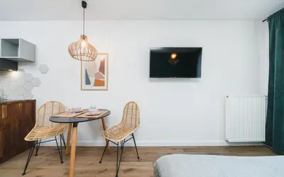 a dining room with a table and two chairs at Apartamenty na Dębnikach - by Upstairs in Kraków