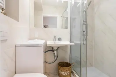 a bathroom with a shower and a toilet and a sink at Apartamenty na Dębnikach - by Upstairs in Kraków