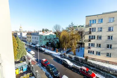 a view of a city street with parked cars and buildings at Apartamenty na Dębnikach - by Upstairs in Kraków