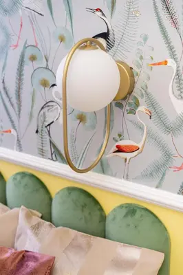 a light fixture hanging on a wall with birds on it at Krakow Old Town Apartments in Kraków