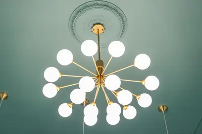 a chandelier in a room with a blue wall at Krakow Old Town Apartments in Kraków