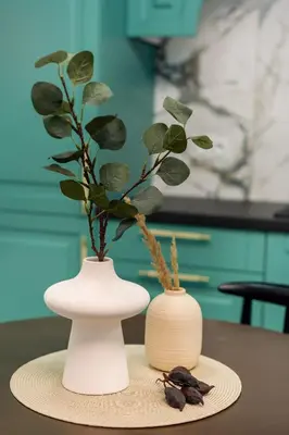 two vases with plants in them sitting on a table at Krakow Old Town Apartments in Kraków