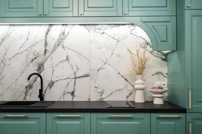 a kitchen with a sink and a marble wall at Krakow Old Town Apartments in Kraków