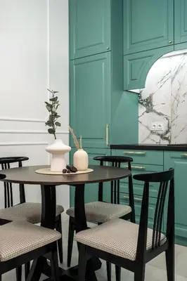 a table with chairs and a vase on top of it at Krakow Old Town Apartments in Kraków