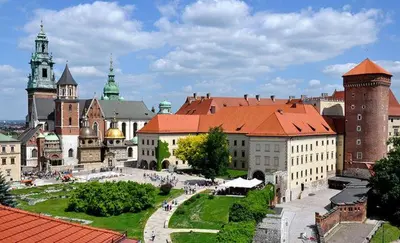 a group of buildings with people walking in front of them at Krakow Old Town Apartments in Kraków