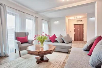 a living room with a couch and a table at Family Apartment by Tyzenhauz in Kraków