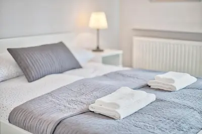 a bed with two white towels on top of it at Family Apartment by Tyzenhauz in Kraków