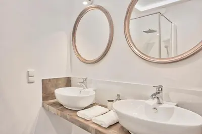a bathroom with two sinks and a large mirror at Family Apartment by Tyzenhauz in Kraków