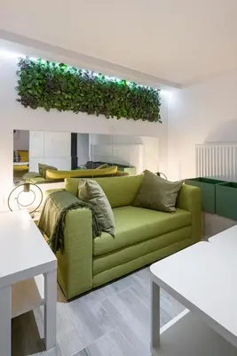 a living room with a green couch and a table at Cosy Apartment in Perfect Location in Kraków
