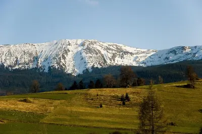 a building covered in snow in front of a fence at OW JĘDRUŚ in Zawoja
