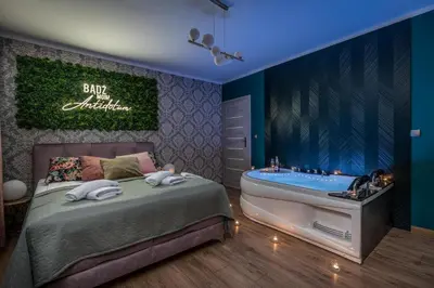 a bedroom with a bed and a bath tub at Exclusive Apartment Centrum 2 in Wadowice