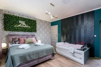 a bedroom with a bed and a bath tub at Exclusive Apartment Centrum 2 in Wadowice