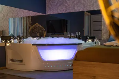 a bathroom with a bath tub with white bubbles at Exclusive Apartment Centrum 2 in Wadowice