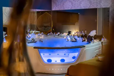 a bath tub with blue water in a room at Exclusive Apartment Centrum 2 in Wadowice