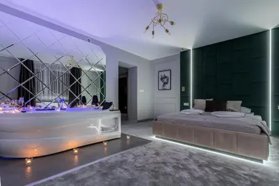 a bedroom with a large bed and a tub at Exclusive Apartment Centrum 2 in Wadowice