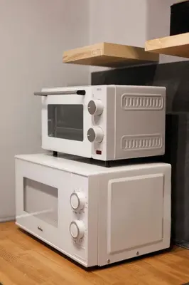 two microwaves are sitting on top of a microwave at Unique studio perfect for couples, Old Podgórze in Kraków