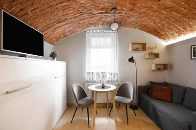 a living room with a couch and a table at Unique studio perfect for couples, Old Podgórze in Kraków