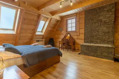 a bedroom with a bed in a wooden cabin at Willa Sołdrówka in Kocierz Rychwałdzki