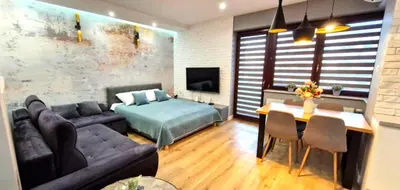 a living room with a couch and a bed and a table at LUXURY BLUE CASCADE studio DOWNTOWN balcony in Kraków