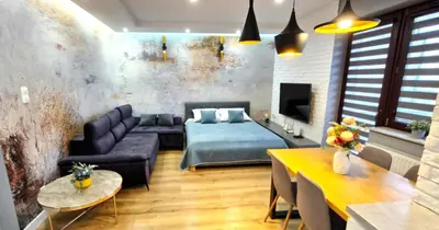 a living room with a bed and a dining room at LUXURY BLUE CASCADE studio DOWNTOWN balcony in Kraków