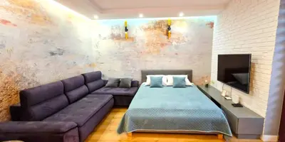 a living room with a couch and a tv at LUXURY BLUE CASCADE studio DOWNTOWN balcony in Kraków
