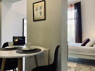 a room with a table and chairs and a bed at Apartment next to Wawel Castle, Vistula River & Old Town Cracow in Kraków