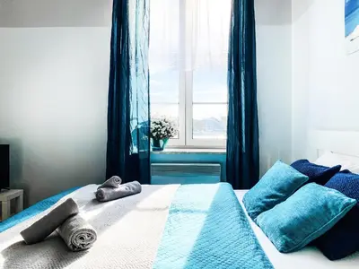 a bedroom with a bed with towels on it at Apartment next to Wawel Castle, Vistula River & Old Town Cracow in Kraków